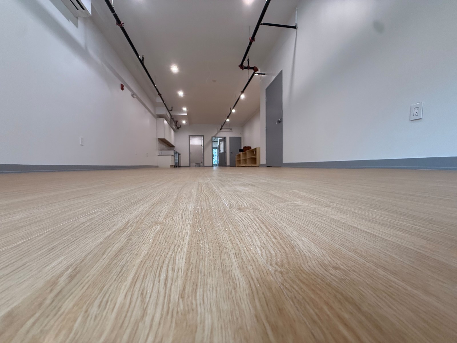 Bright open space with new wood-look luxury vinyl flooring installed by GLR Flooring