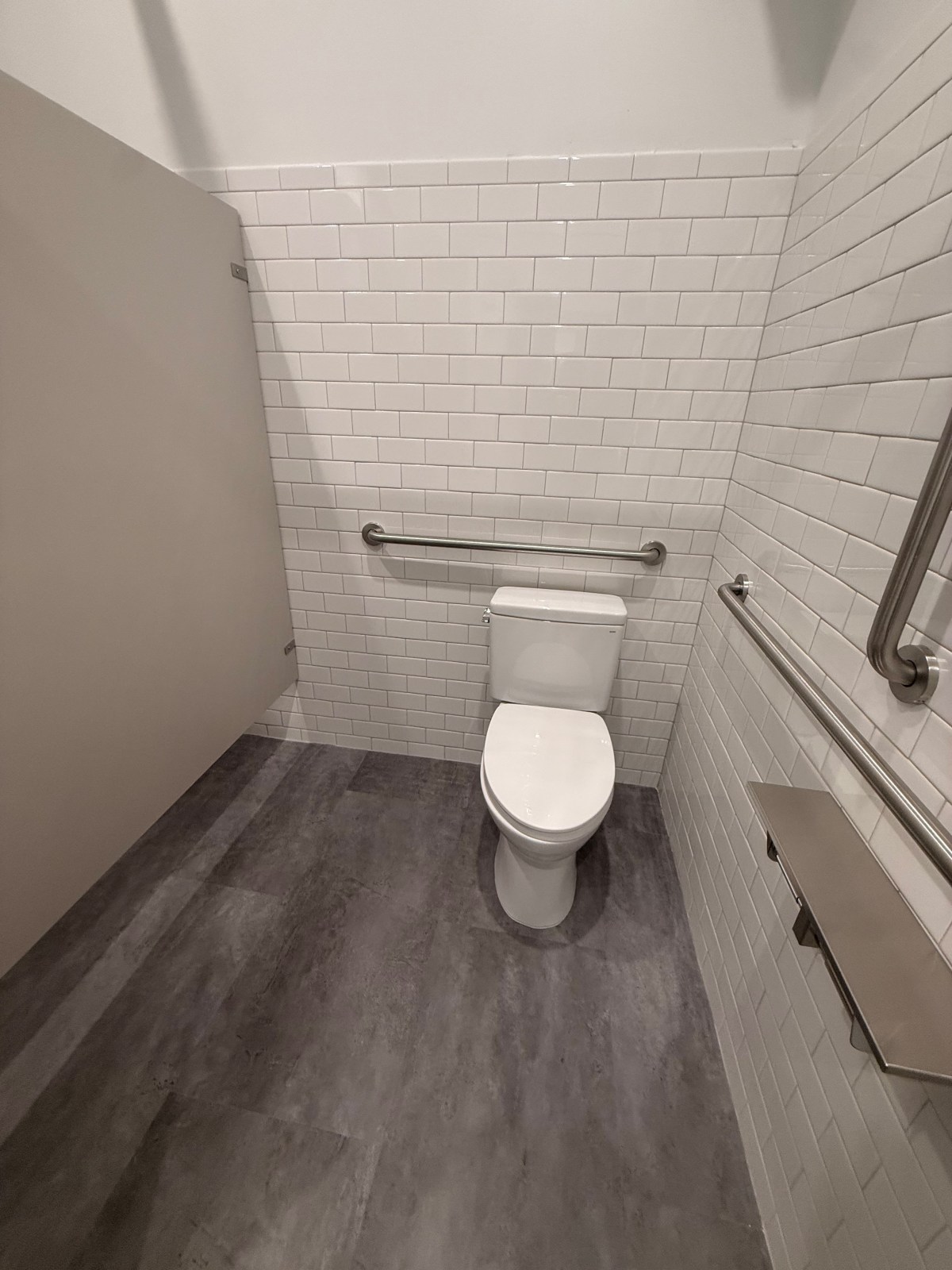 Accessible restroom with white wall tile installed by GLR Flooring
